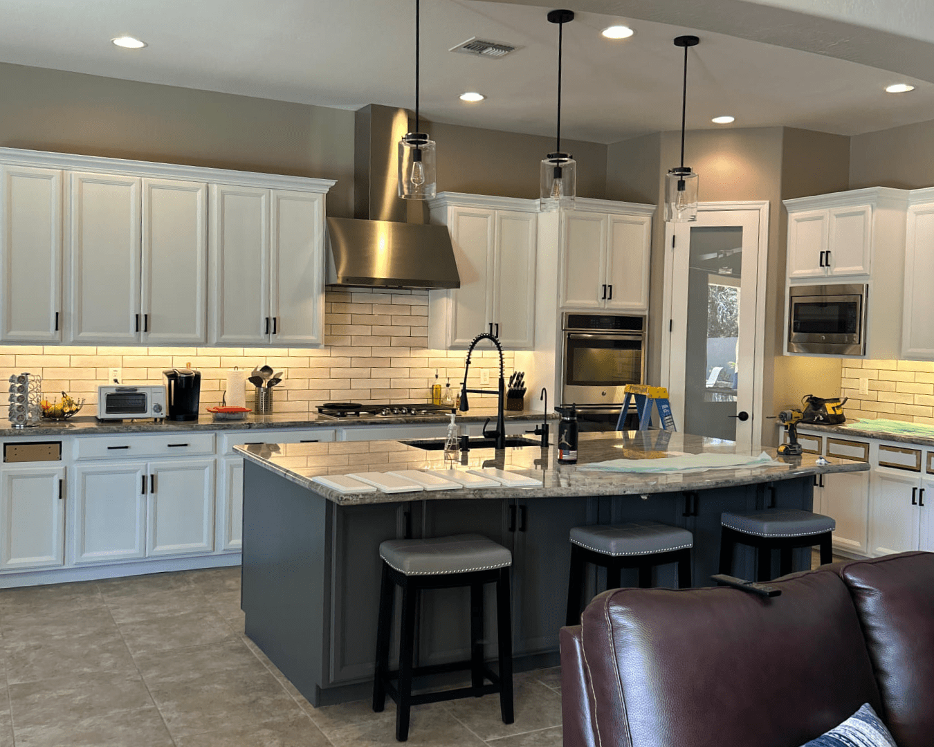 Newly painted green and white kitchen cabinets