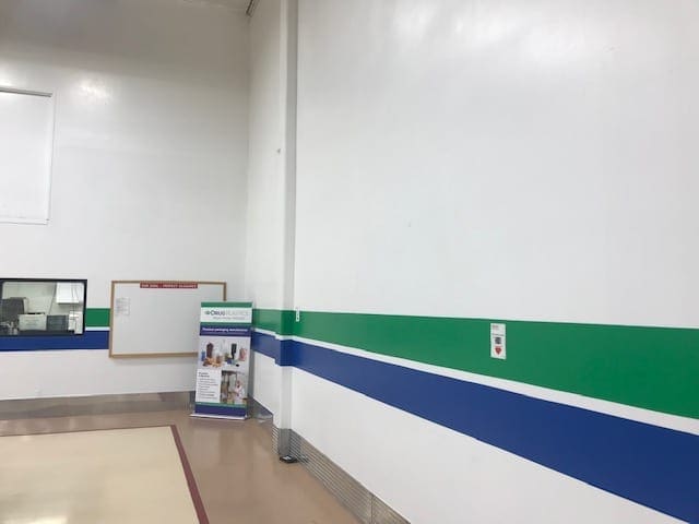 Arizona Painting Company's skilled industrial painters providing durable protective coatings for machinery and structures, enhancing both longevity and aesthetics. Industrial Room being painted with blue and green stripes.