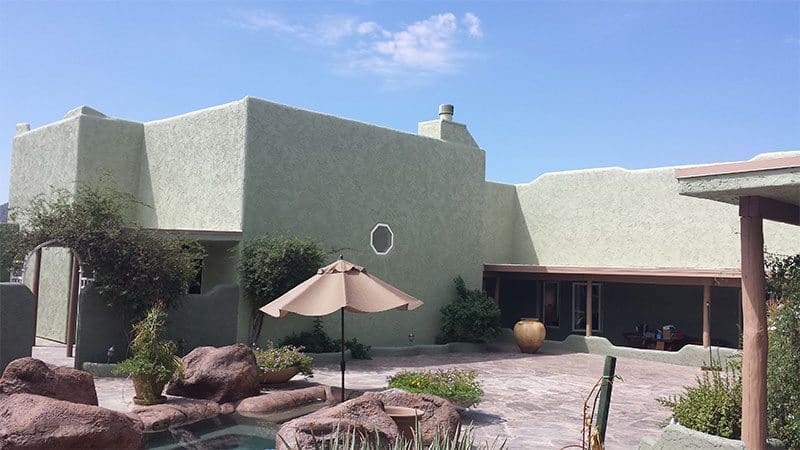Light green home transformed by Arizona Painting Company: A freshly painted residential exterior, radiating a soothing and refreshing ambiance, highlighting the craftsmanship of Arizona Painting Company.
