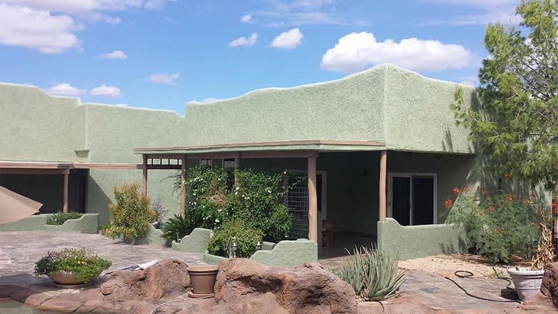 Light green home transformed by Arizona Painting Company: A freshly painted residential exterior, radiating a soothing and refreshing ambiance, highlighting the craftsmanship of Arizona Painting Company.