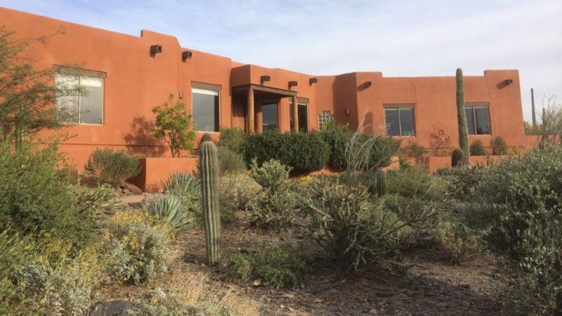 Sonoran Style Residential exterior transformed by Arizona Painting Company: A newly painted brown home, displaying their expert craftsmanship and attention to detail.