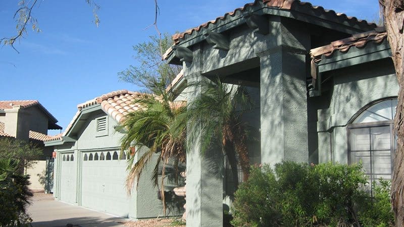 Residential exterior transformed by Arizona Painting Company: A newly painted grey home, displaying their expert craftsmanship and attention to detail.