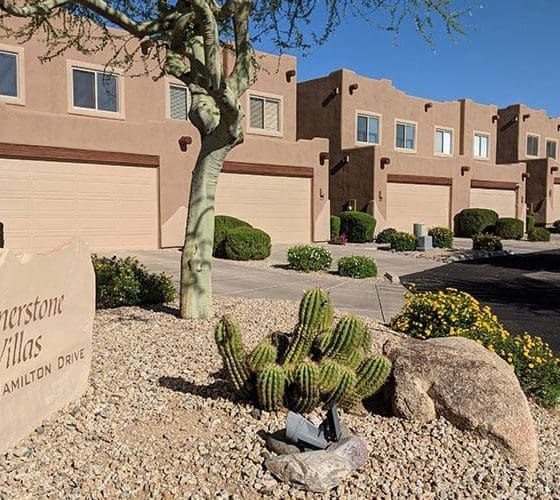 Arizona Painting Company's expert team offering HOA painting services, revitalizing community properties with quality coatings for lasting beauty and enhanced curb appeal. Brown residential building being shown in image for HOA painting.