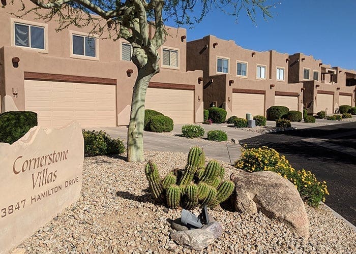 Arizona Painting Company's expert team offering HOA painting services, revitalizing community properties with quality coatings for lasting beauty and enhanced curb appeal. Brown residential building being shown in image for HOA painting.