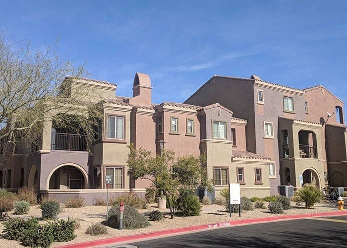 Arizona Painting Company's expert team offering HOA's painting services, revitalizing community properties with quality coatings for lasting beauty and enhanced curb appeal. Brown apartment building being shown as part of HOA painting offers.