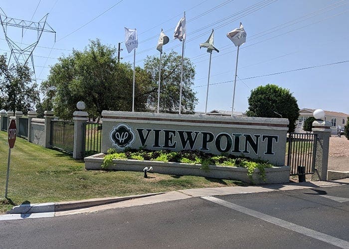 Arizona Painting Company's expert team offering HOA painting services, revitalizing community properties with quality coatings for lasting beauty and enhanced curb appeal. Community sign reading Viewpoint is being shown.