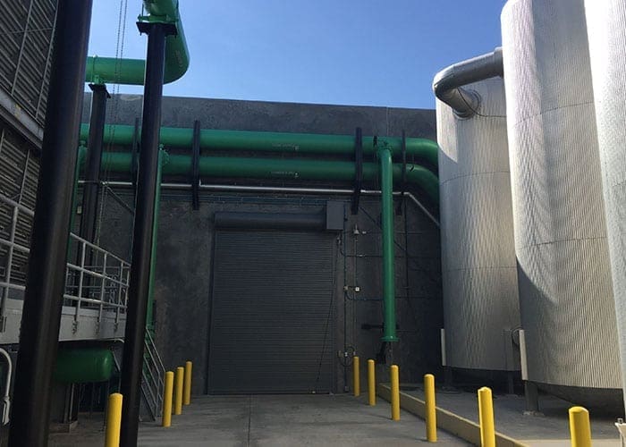 Arizona Painting Company's skilled industrial painters providing durable protective coatings for machinery and structures, enhancing both longevity and aesthetics. Green industrial painted machinery.