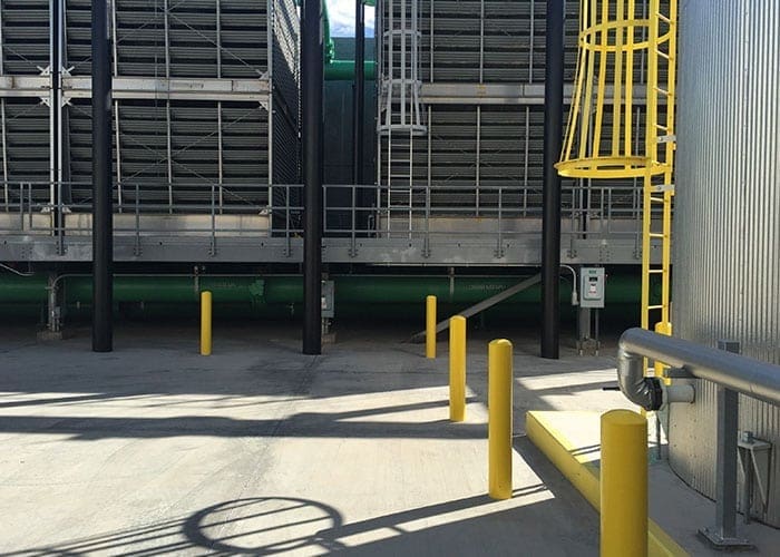 Arizona Painting Company's skilled industrial painters providing durable protective coatings for machinery and structures, enhancing both longevity and aesthetics. Yellow painted machinery being shown.