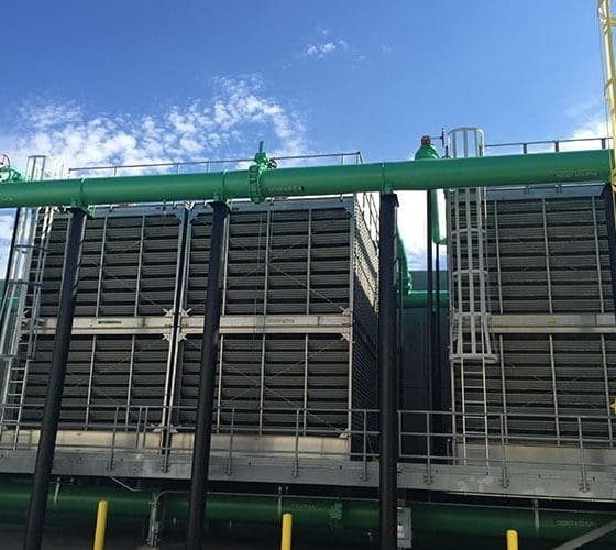 Arizona Painting Company's skilled industrial painters providing durable protective coatings for machinery and structures, enhancing both longevity and aesthetics. Green machinery being shown.