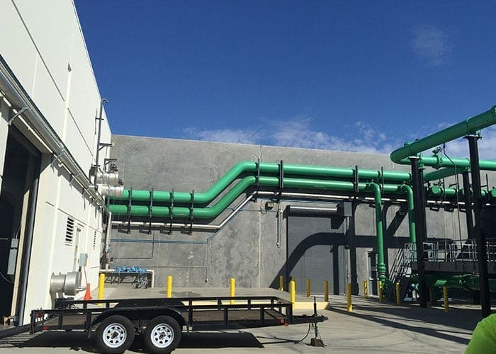 Arizona Painting Company's skilled industrial painters providing durable protective coatings for machinery and structures, enhancing both longevity and aesthetics. Green industrial painted machinery.