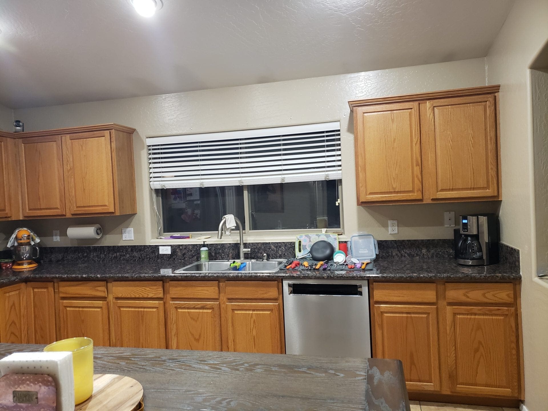 Arizona Painting Company offers Cabinet Painting: Newly painted cabinets bring a fresh and stylish transformation to any space. Old brown kitchen cabinets before being painted and transformed.